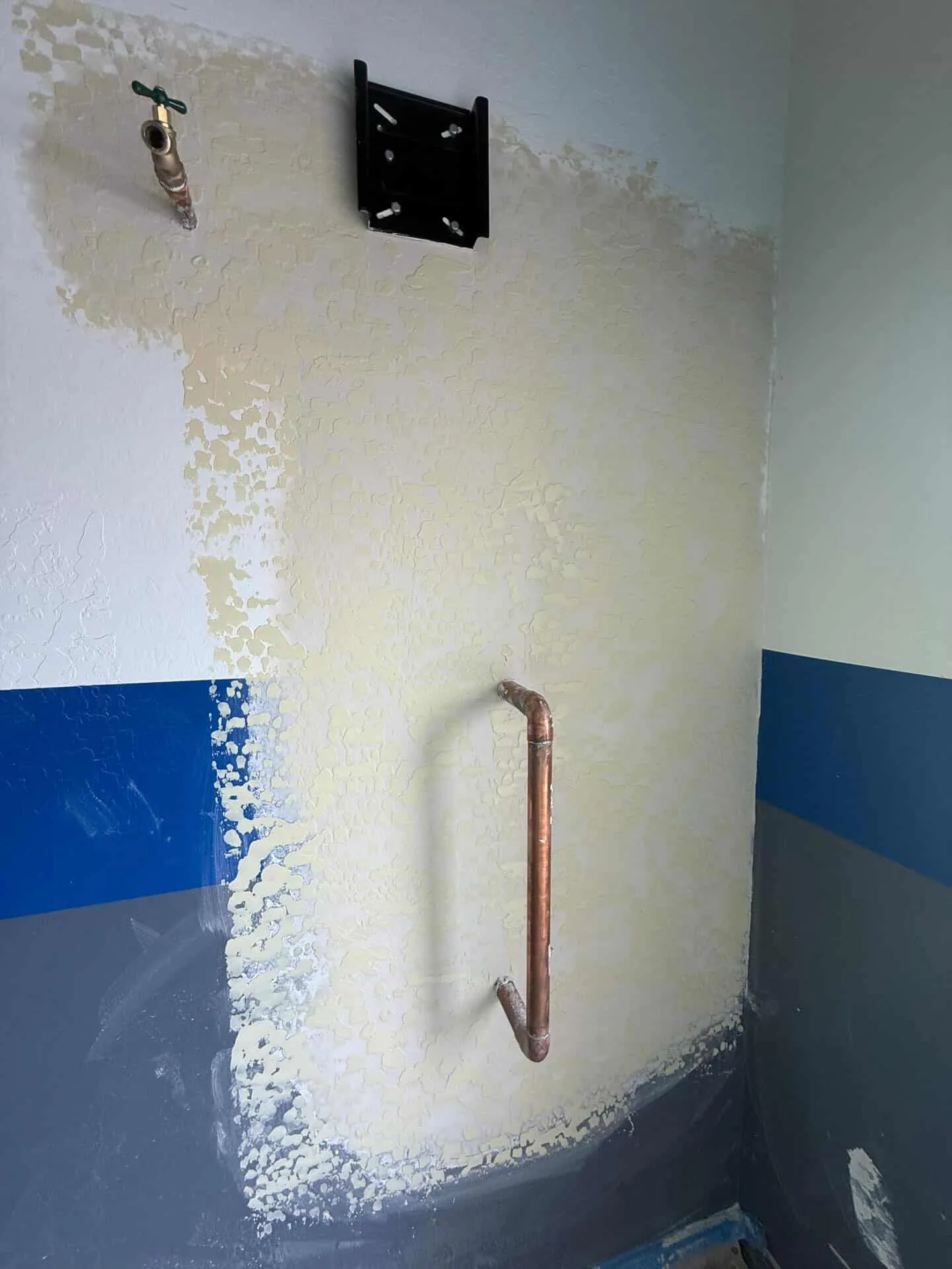 Texture matching after plumbing repair in a Phoenix, AZ garage